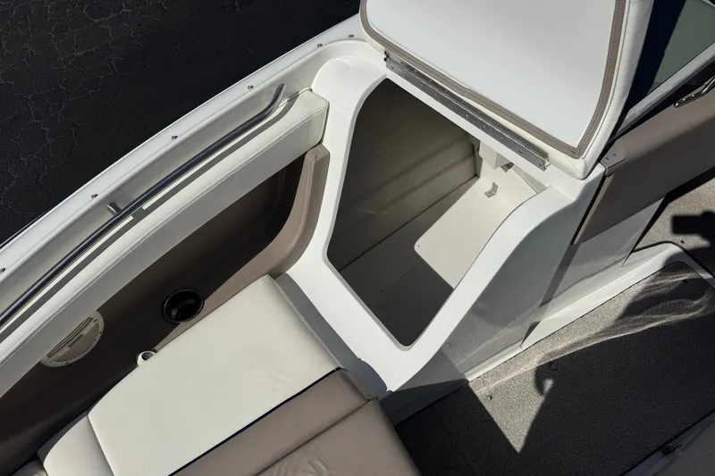 Slide: The Image of Open storage compartment on a 2001 Cobalt 232 boat, showcasing interior space. - 16