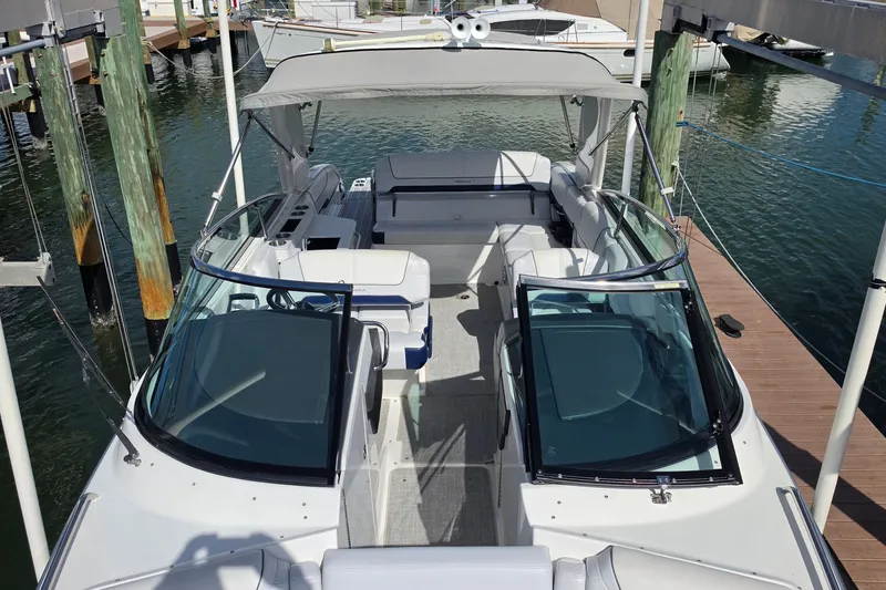 Slide: The Image of 2023 Formula 290 Bowrider boat docked, featuring spacious seating and sleek design. - 16