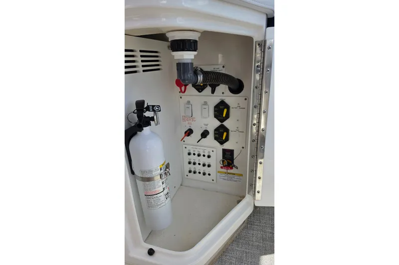Slide: The Image of 2023 Formula 290 Bowrider control panel with fire extinguisher and switches. - 50