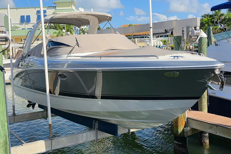 Slide: The Image of 2023 Formula 290 Bowrider boat docked at marina under clear blue sky. - 38