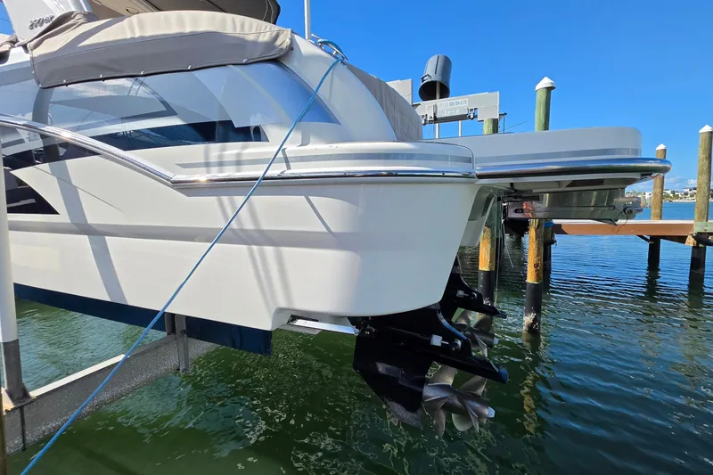 Slide: The Image of 2023 Formula 290 Bowrider boat docked, showcasing sleek design and dual propellers. - 41