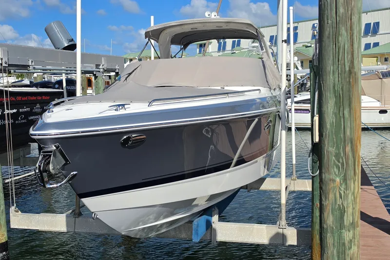 Slide: The Image of 2023 Formula 290 Bowrider boat docked at marina under clear blue sky. - 39
