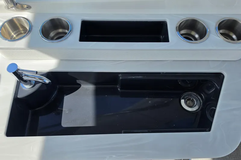 Slide: The Image of 2023 Formula 290 Bowrider sink area with cup holders and faucet. - 46