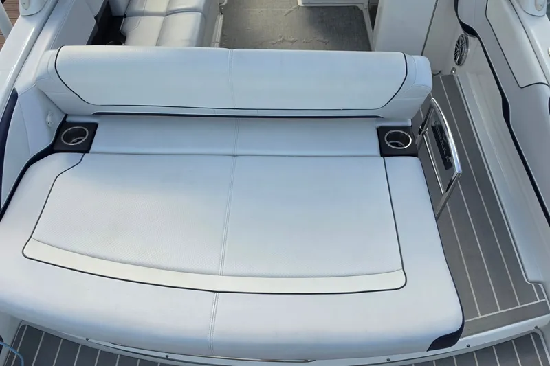 Slide: The Image of 2023 Formula 290 Bowrider boat interior with white seating and cup holders. - 35