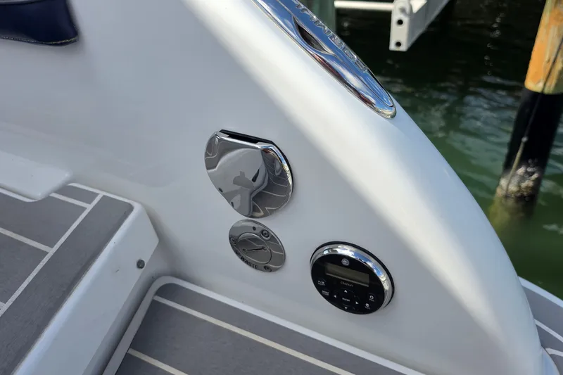 Slide: The Image of 2023 Formula 290 Bowrider boat controls and waste outlet on deck. - 42