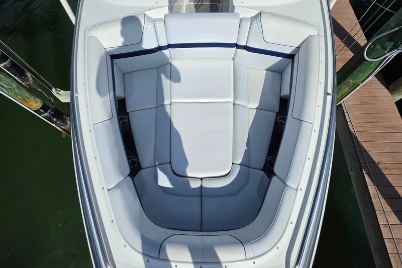 Slide: The Image of 2023 Formula 290 Bowrider boat with spacious seating, docked by wooden pier. - 15