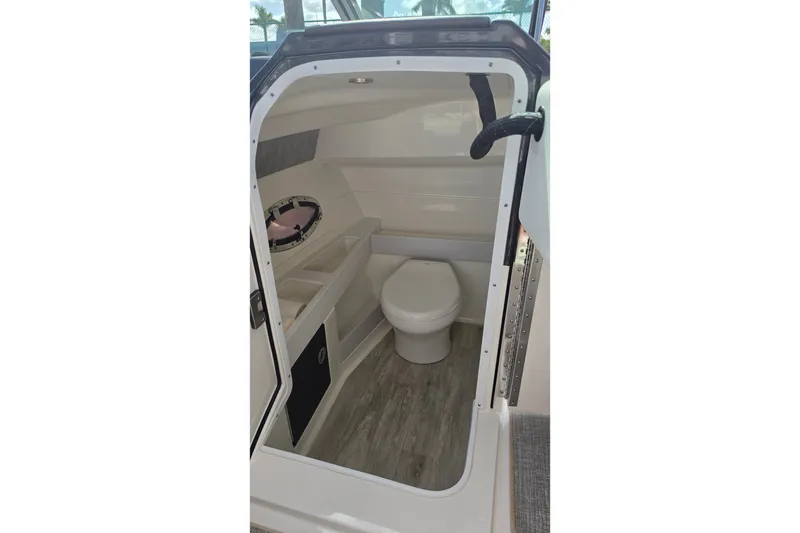Slide: The Image of 2023 Formula 290 Bowrider interior cabin with toilet and storage compartments. - 49