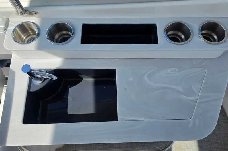 Slide: The Image of 2023 Formula 290 Bowrider sink area with cup holders and faucet. - 47