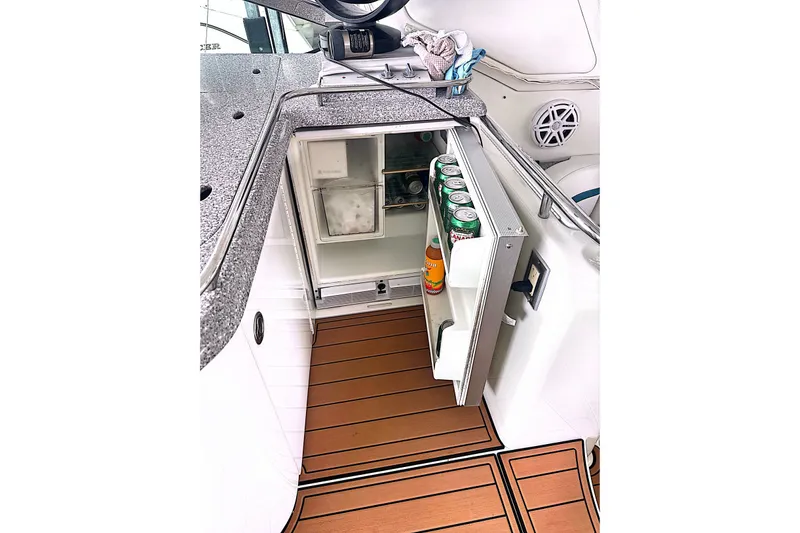 Slide: The Image of Open mini fridge on 2006 Formula 48 Yacht with drinks inside, wooden flooring visible. - 14