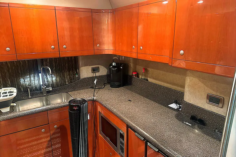 Slide: The Image of Luxurious kitchen interior of a 2006 Formula 48 Yacht with wooden cabinets and modern appliances. - 26