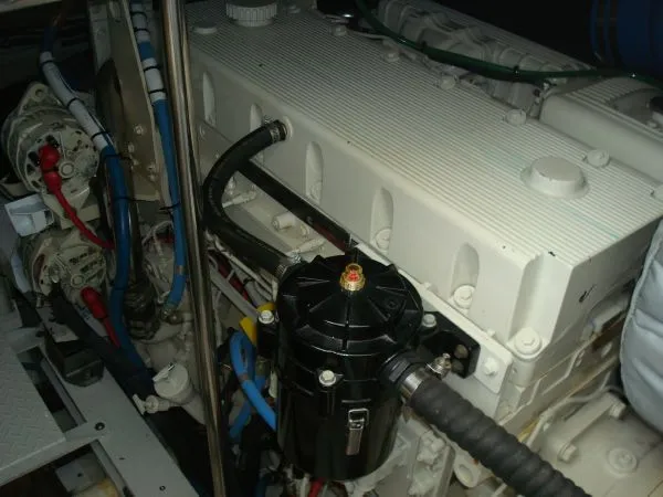 Slide: The Image of An engine room with a large white engine and various hoses and cables. - 33