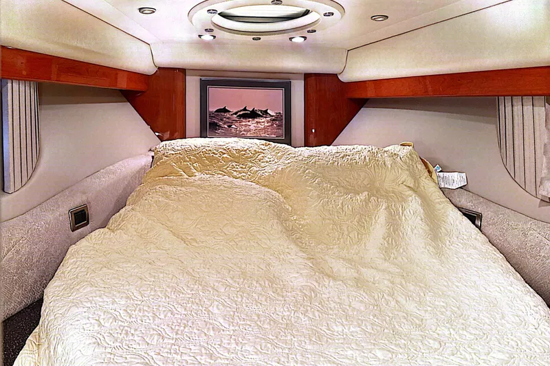 Slide: The Image of Luxurious interior of a 2006 Formula 48 Yacht with cozy bedding and elegant wood accents. - 69