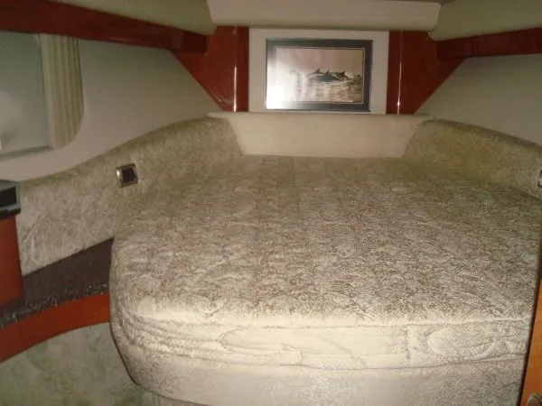 Slide: The Image of The 2006 Formula 48 Yacht cabin features a large cushioned bed with a picture on the wall. - 28