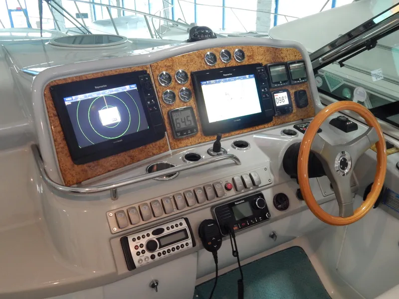 Slide: The Image of The 2006 Formula 48 Yacht cockpit features modern navigation equipment and a wooden steering wheel. - 39