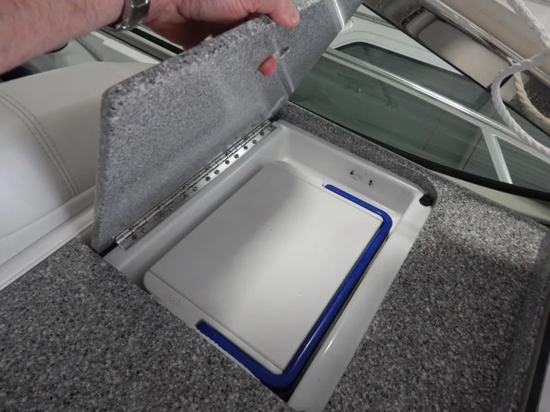 Slide: The Image of A gray, padded lid is lifted to reveal a white storage compartment with a blue trim. - 16