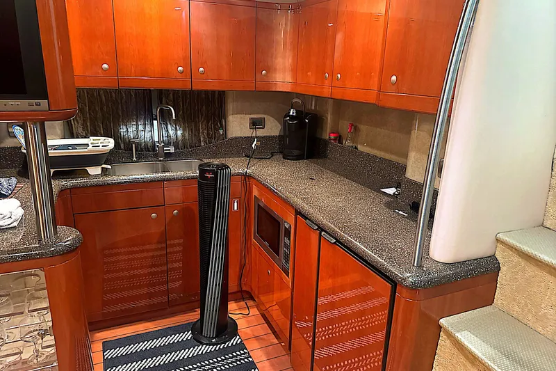 Slide: The Image of Luxurious kitchen interior of a 2006 Formula 48 Yacht with wooden cabinetry and modern appliances. - 71