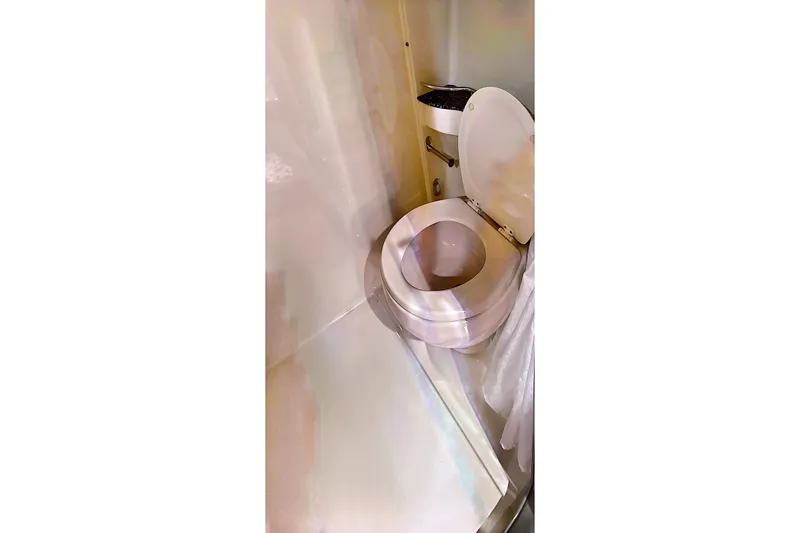 Slide: The Image of Bathroom interior of a 2006 Formula 48 Yacht, featuring a compact toilet design. - 60