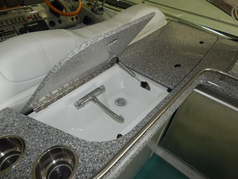 Slide: The Image of The 2006 Formula 48 Yacht features a stylish galley area with a sink and storage. - 21