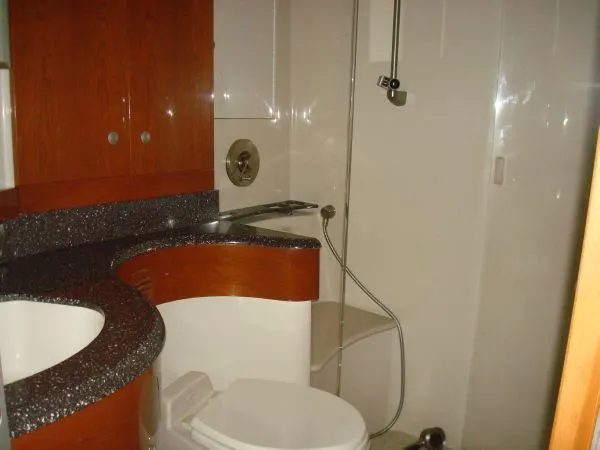 Slide: The Image of Bathroom with wood paneling, sink, toilet, and shower in a yacht. - 29