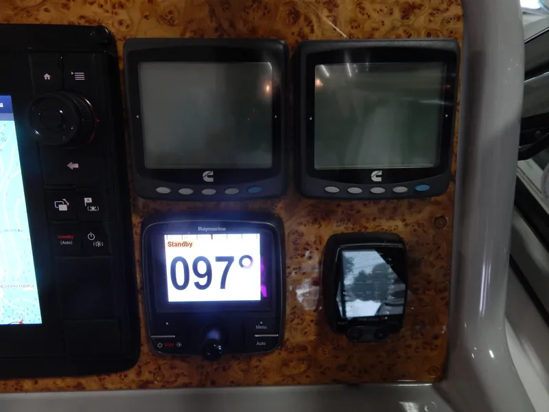 Slide: The Image of The image shows a navigation system with multiple screens and a compass on a yacht. - 40