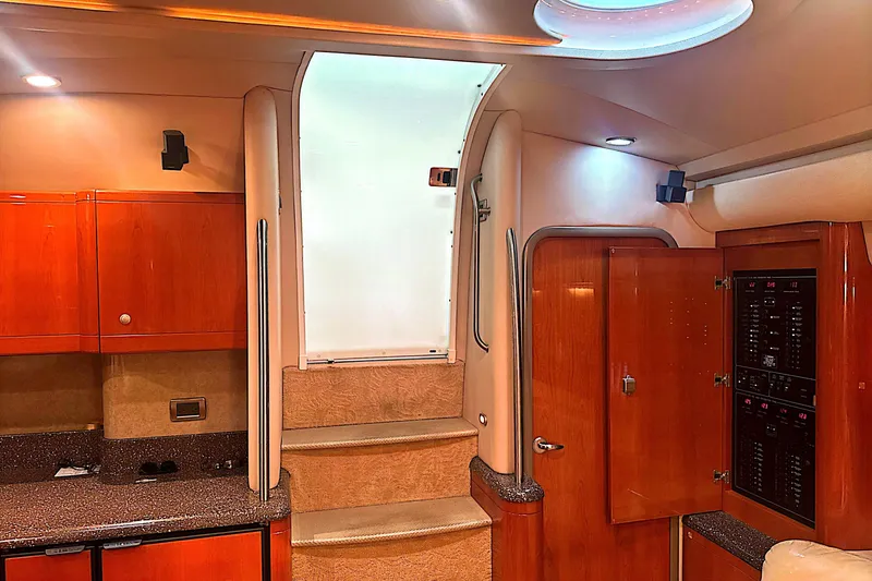 Slide: The Image of Interior of a 2006 Formula 48 Yacht featuring wooden cabinetry and carpeted stairs. - 23