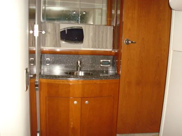 Slide: The Image of Interior of the 2006 Formula 48 Yacht with wooden cabinets and a sink. - 31