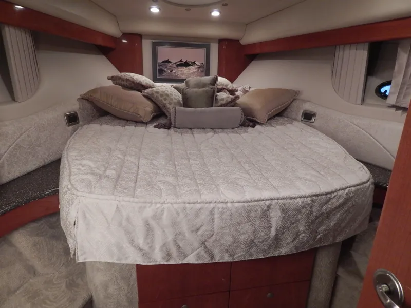 Slide: The Image of Luxurious cabin with a large, cozy bed, surrounded by elegant wood accents and soft pillows. - 45