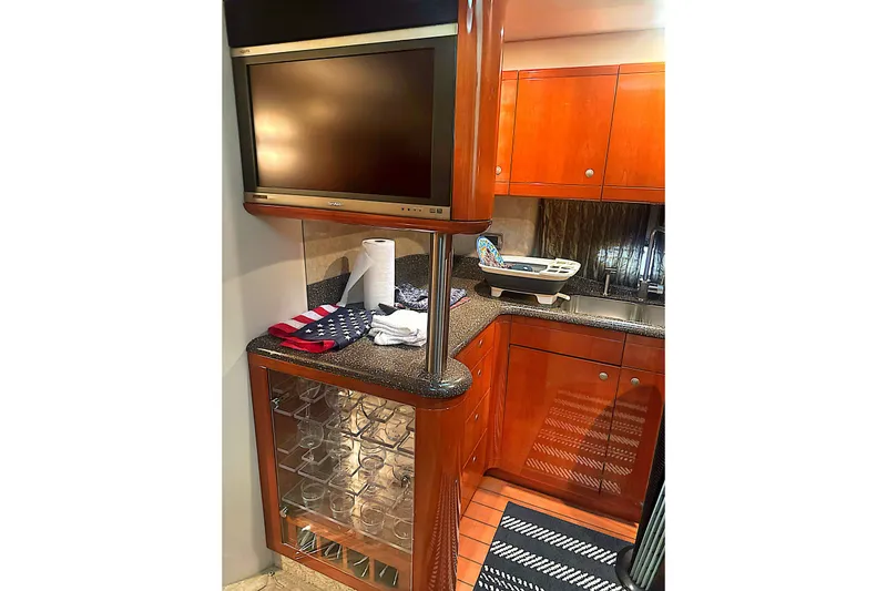 Slide: The Image of Luxurious 2006 Formula 48 Yacht kitchen with wooden cabinetry and modern amenities. - 59