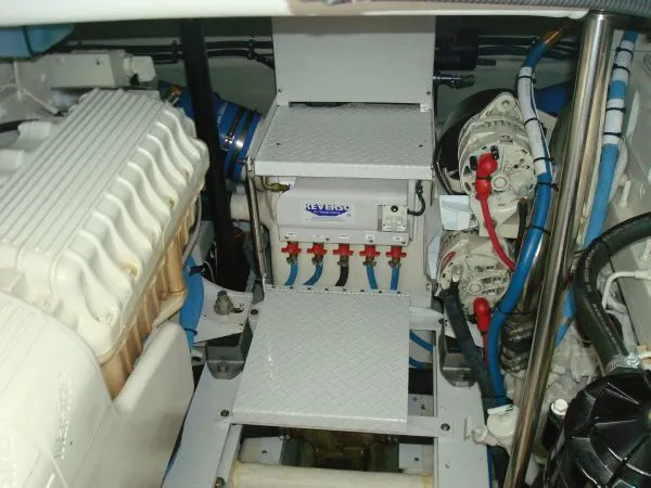 Slide: The Image of The engine room of a 2006 Formula 48 Yacht with various mechanical components and cables. - 36