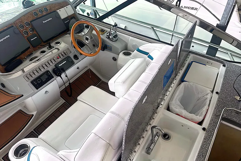Slide: The Image of Cockpit of 2006 Formula 48 Yacht with steering wheel, navigation screens, and seating. - 13