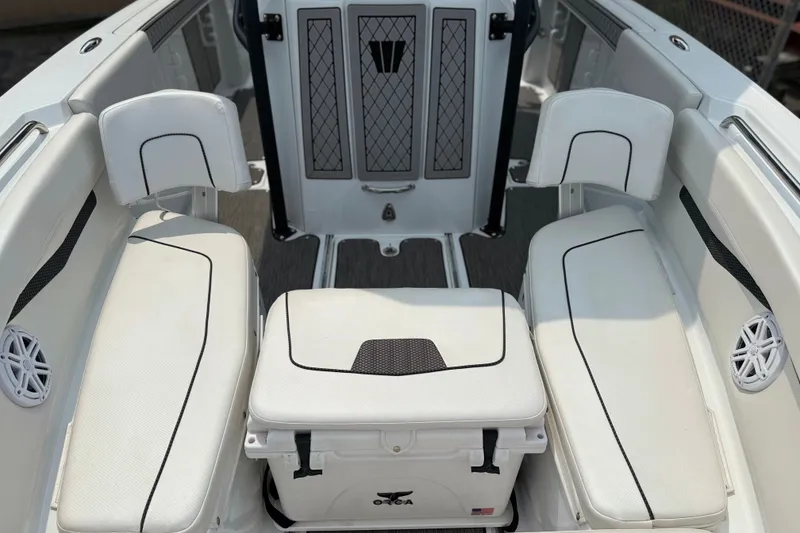 Slide: The Image of 2022 Wellcraft 262 Fisherman boat interior with white seating and storage area. - 22