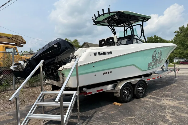 Slide: The Image of 2022 Wellcraft 262 Fisherman boat on trailer, featuring dual engines and sleek design. - 24