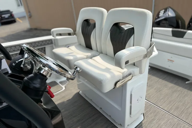 Slide: The Image of 2022 Wellcraft 262 Fisherman boat interior with dual helm seats and steering wheel. - 10