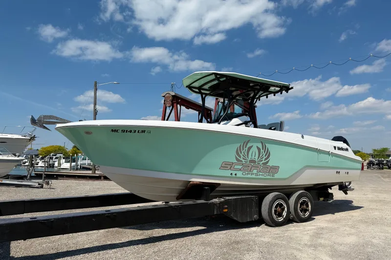 Slide: The Image of 2022 Wellcraft 262 Fisherman boat on trailer under blue sky. - 2