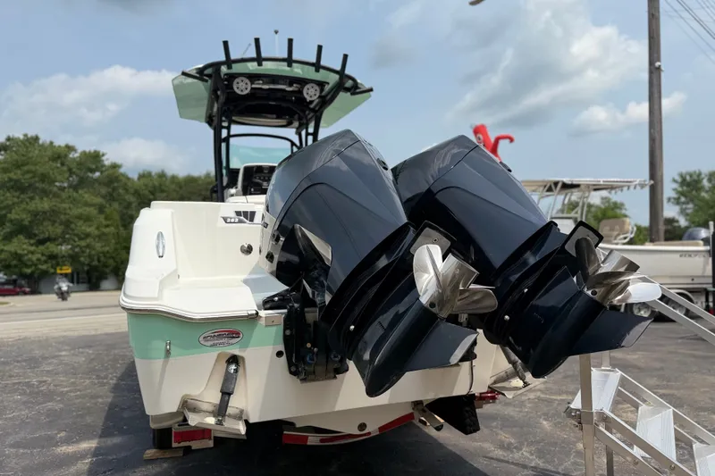 Slide: The Image of 2022 Wellcraft 262 Fisherman boat with dual outboard motors, parked on a trailer. - 30