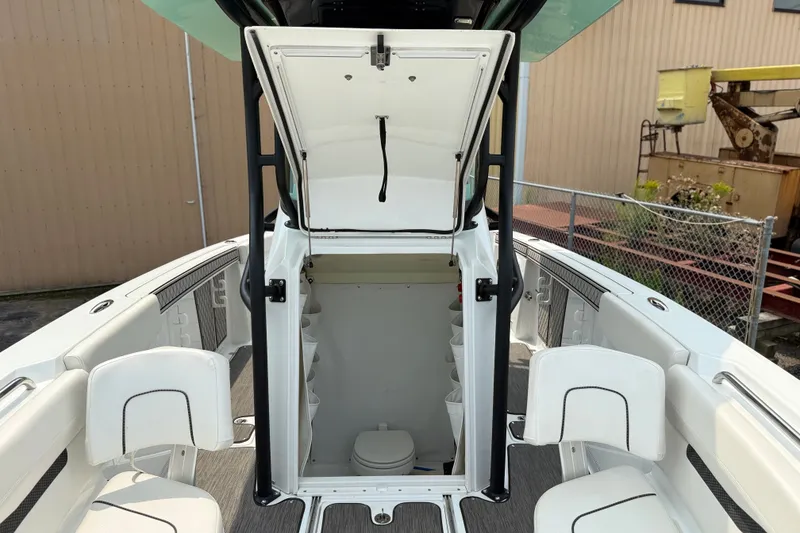 Slide: The Image of 2022 Wellcraft 262 Fisherman boat interior with open storage compartment and seating. - 12