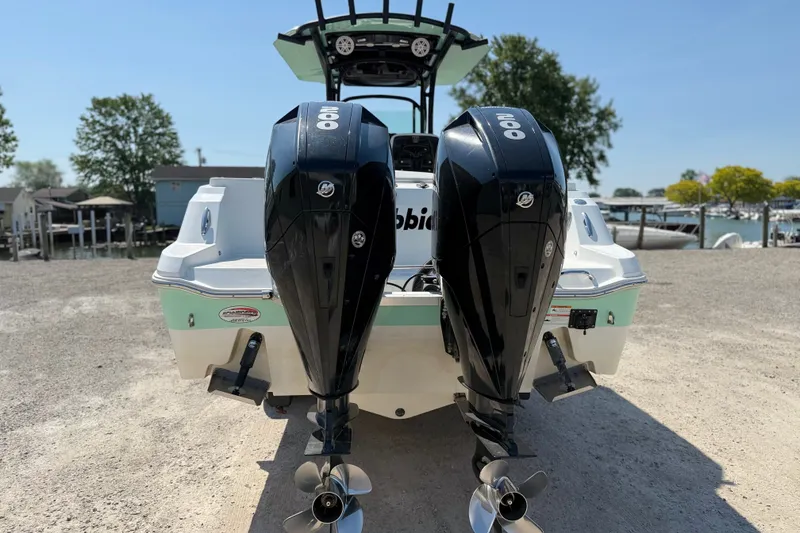 Slide: The Image of 2022 Wellcraft 262 Fisherman boat with dual outboard engines, parked on a sunny day. - 29