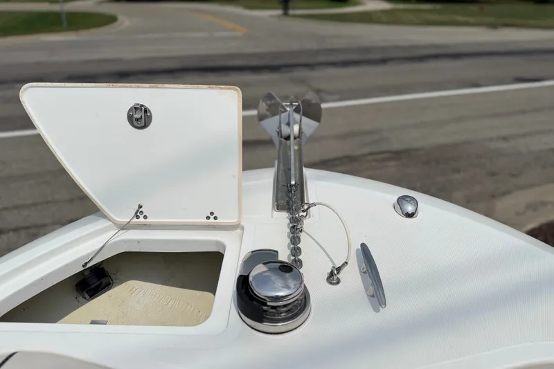 Slide: The Image of 2022 Wellcraft 262 Fisherman boat anchor compartment with open hatch and chain. - 21