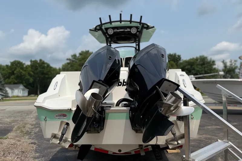 Slide: The Image of 2022 Wellcraft 262 Fisherman boat with dual outboard motors, rear view. - 31