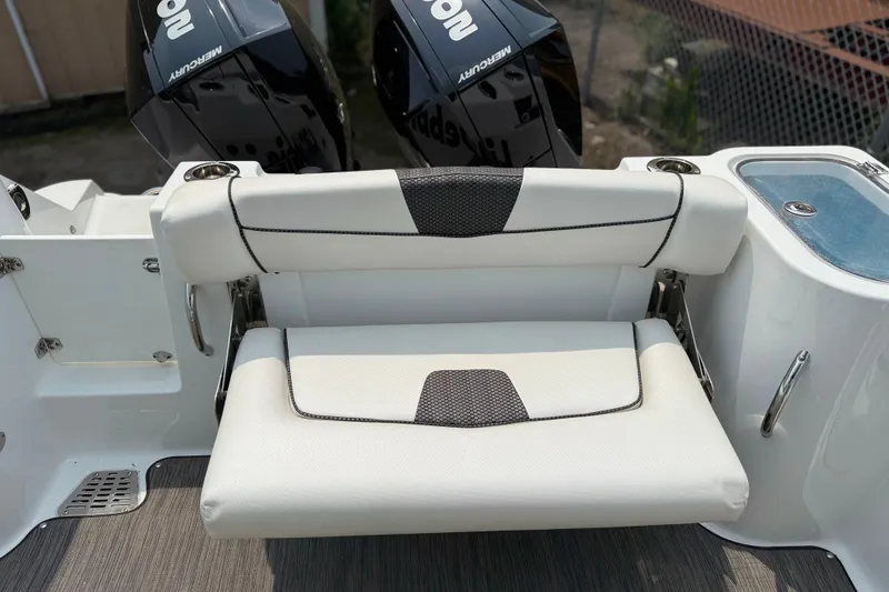 Slide: The Image of 2022 Wellcraft 262 Fisherman boat seat with dual Mercury engines in the background. - 28