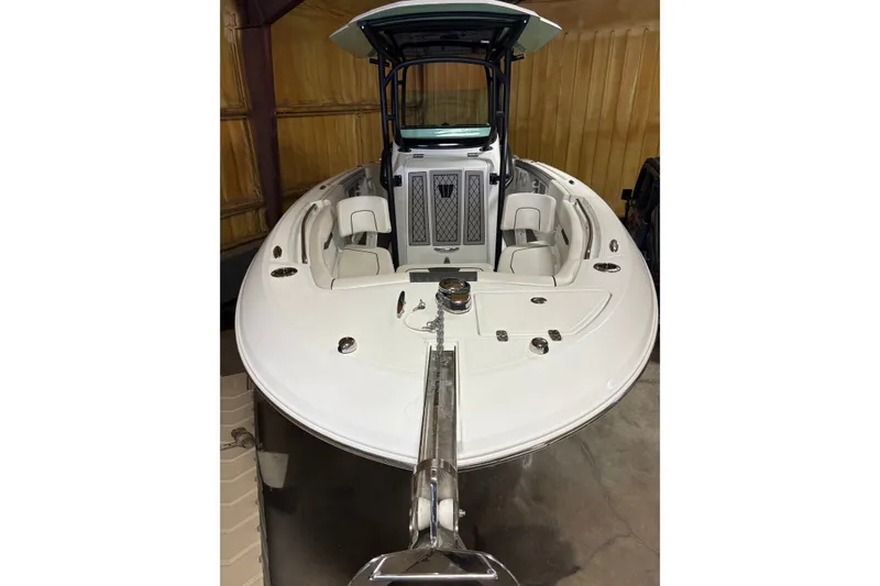 Slide: The Image of 2022 Wellcraft 262 Fisherman boat in storage, showcasing sleek design and spacious seating. - 6