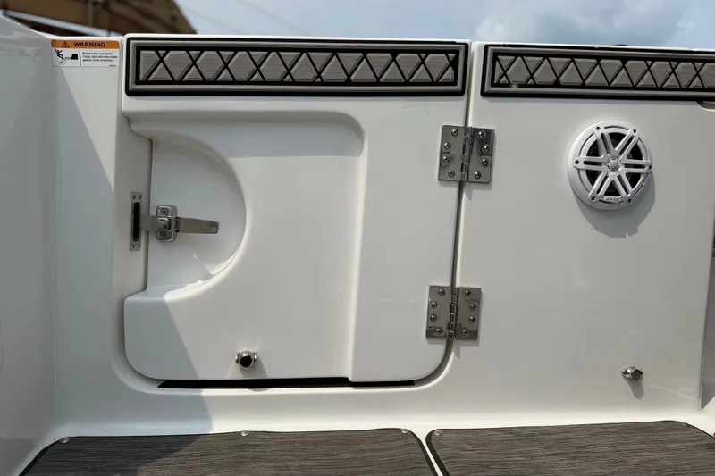 Slide: The Image of 2022 Wellcraft 262 Fisherman boat interior with storage compartment and speaker. - 15