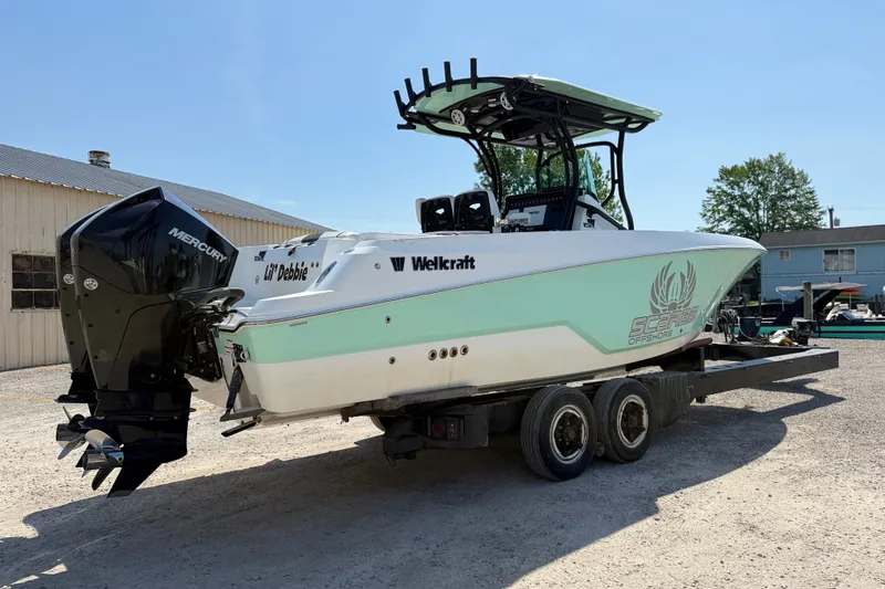 Slide: The Image of 2022 Wellcraft 262 Fisherman boat on trailer, featuring Mercury outboard engine. - 25