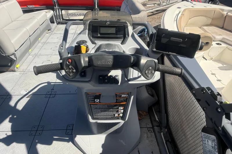 Slide: The Image of 2023 Sea-Doo Switch Cruise 21 dashboard with steering controls and seating area. - 13