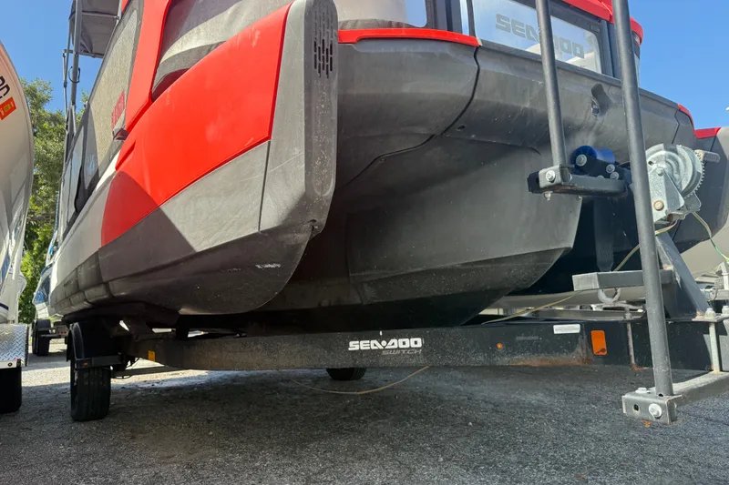 Slide: The Image of 2023 Sea-Doo Switch Cruise 21 on trailer, showcasing its sleek red and black design. - 1
