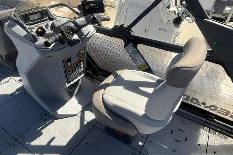 Slide: The Image of 2023 Sea-Doo Switch Cruise 21 helm with steering wheel and comfortable seating. - 12