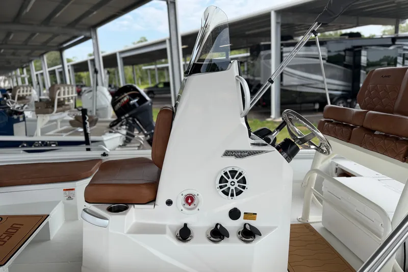 Slide: The Image of Avid 21 Fusion 2027 boat interior with brown seating and modern steering console. - 19