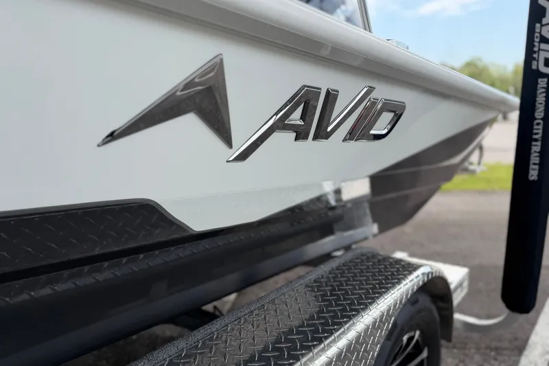Slide: The Image of 2027 Avid 21 Fusion boat on trailer, showcasing sleek design and branding. - 21