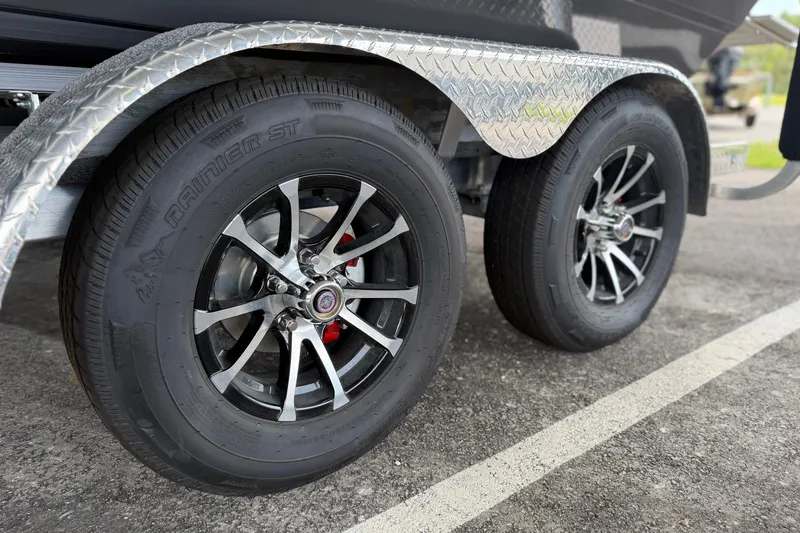 Slide: The Image of Close-up of Avid 21 Fusion 2027 trailer wheels with chrome rims and diamond plate fender. - 22