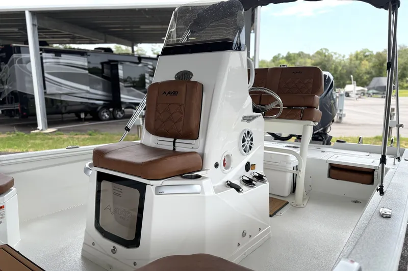 Slide: The Image of 2027 Avid 21 Fusion boat interior with brown seating and modern console design. - 18